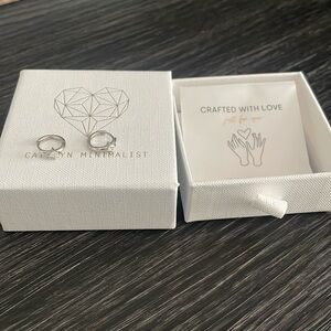 Silver hoop earrings by Caitlyn Minimalist.